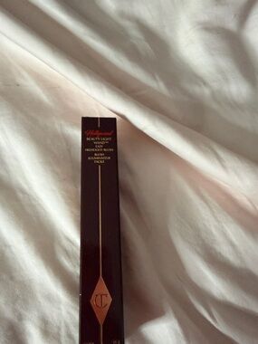 Charlotte Tilbury Beauty Light Wand in Deep Burgundy & Rose Gold Accents